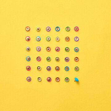 Top view of colored office stationery pins.