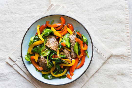 Beef stir fry with sweet bell peppers and baby spinach