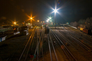 Night railway station with artificial lighting