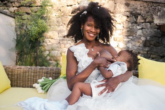 bride breastfeeding her baby