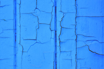 Old paint texture with cracks. An old blue door.