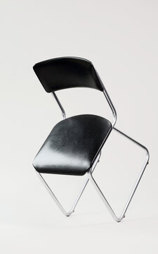 Vintage 1970 tubular steel chair balancing