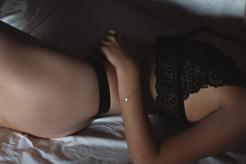 Sexy tightening female body dressing in seductive underwear.