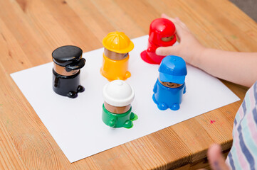 The child learns to know colors. Little toddler boy playing colors figurines cups learning materials in a montessori methodology school being manipulated by children.