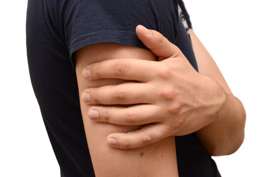 Pain in forearm of a young man, holding his hand to a sore spot. Horizontal photo isolated, medicine concept.