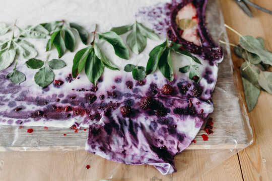 Unusual kind of a create. Decorating clothes with berries and leaves. Pattern on a white t-shirt.