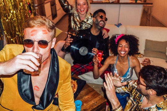 Man drinking alcohol while having fun with friends . Lipstick Ki