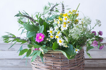 Fototapeta na wymiar Healing herbs in basket on wooden background