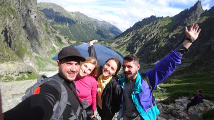 Happy climbers celebrating ascension on top of mountains.