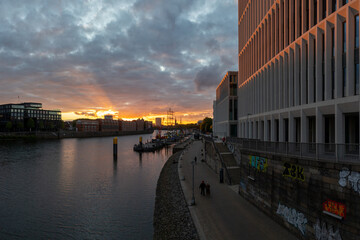 Fototapeta na wymiar panorama of the river Weser in Bremen, Germany with city center and beautiful clouds at sunset