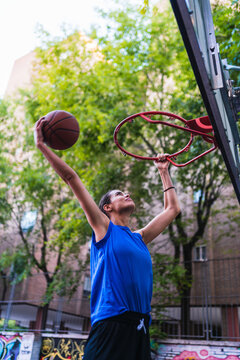 Female basketball player doing a hit