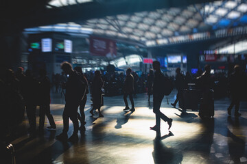 Indoor view of passenger terminal with people silhouettes walking by, train railway station with traveler silhouette crowd, modern terminus interior
