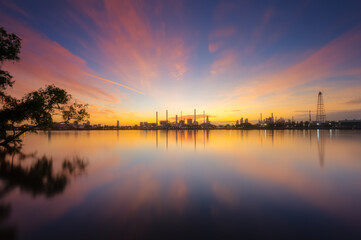 oil refinery plant chemical factory and power plant with many storage tanks and pipelines at sunrise