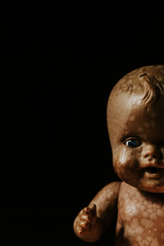 close up of a vintage baby doll, in the shadow