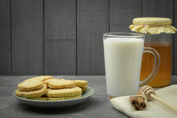 Cookies with milk and honey as a background for text