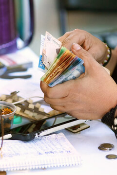 Counting money at a market