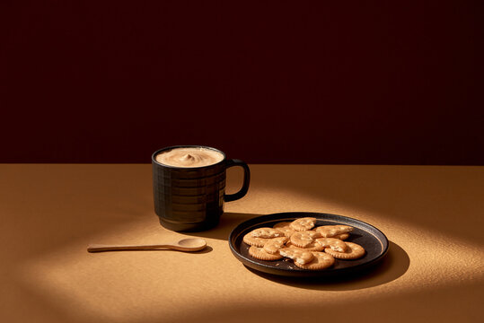 Cup of coffee and plate with chocolate cookies