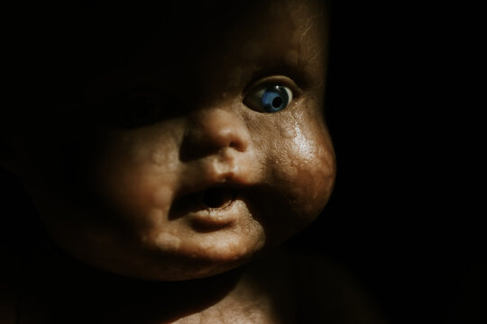 close up of a vintage baby doll, in the shadow - Powered by Adobe