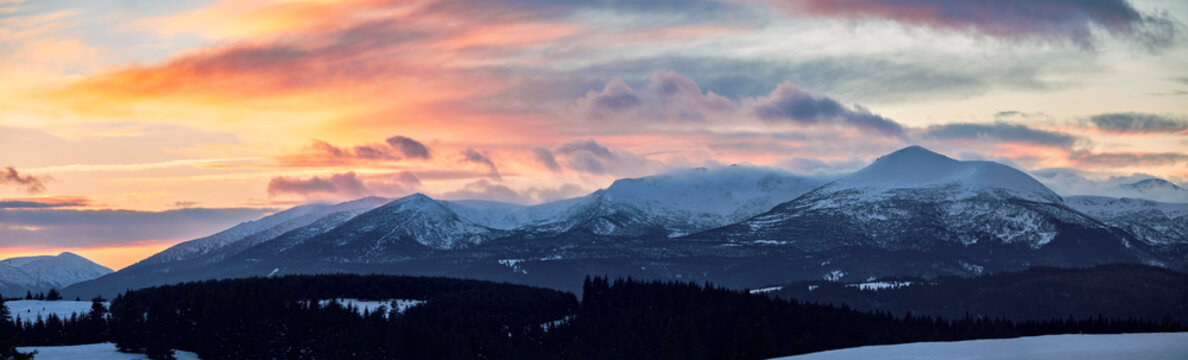 Sunset clouds over snowy mountains