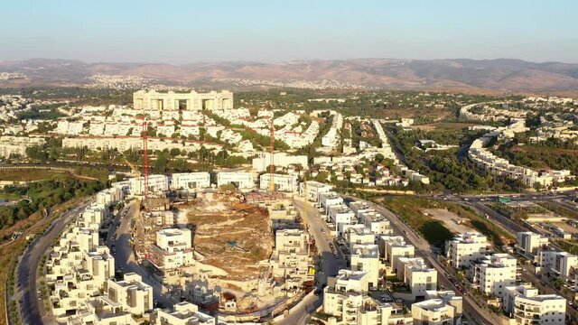 Construction Site and Cranes silhouette, In modiin City,Israel,Aerial view, 
Drone view,July, Sunset,2020
