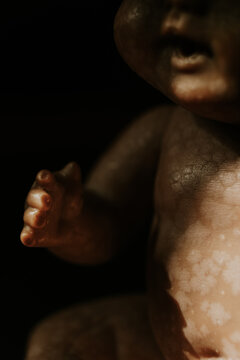 close up of a vintage baby doll, in the shadow