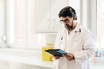 Portrait of a doctor looking at his phone