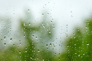 Raindrops on a window pane, green transparent background.