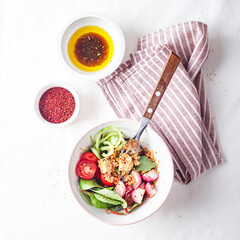 Fresh salad with couscous, tomatoes, cucumber, radish and chard.