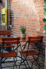 Outdoor restaurant with fresh flowers on the wooden table
