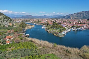 Naklejka na ściany i meble Dalyan canal view and settlement, excursion bout tour on Dalyan river valley. Dalyan is popular tourist destination in Turkey. Aerial view from drone.