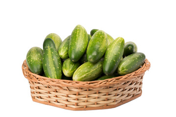 cucumbers in wicker basket on isolated white background