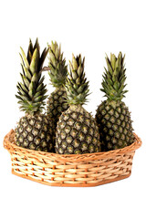 pineapples in wicker basket on isolated white background