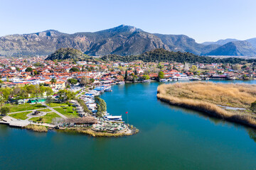 Fototapeta na wymiar Dalyan canal view and settlement, excursion bout tour on Dalyan river valley. Dalyan is popular tourist destination in Turkey. Aerial view from drone.
