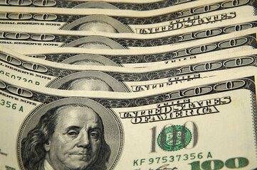 A bunch of 100 dollar bills. Close up view of the middle part of the bills
