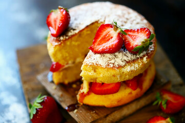 Selective focus. Strawberry Cake Sponge cake with fresh strawberries and cream. Victoria sponge cake on a dark background.