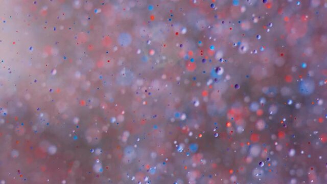 Abstract Chaotic Motion of Particles in Space. Slow Motion Bright Colors Bubbles Oil Paint Universe Moving Multicolored Close Up. Acrylic Paint. Fantastic Hypnotic Surface. Big Bang. Nanotechnology.