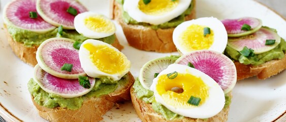 watermelon radish sandwich with avocado and egg. healthy balanced breakfast. bright toast