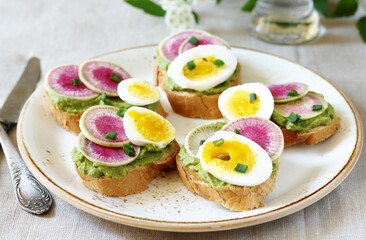 watermelon radish sandwich with avocado and egg. healthy balanced breakfast. bright toast