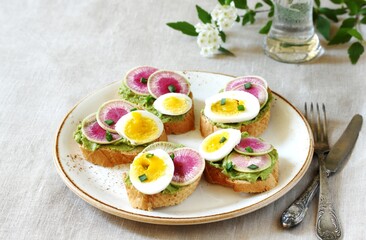 watermelon radish sandwich with avocado and egg. healthy balanced breakfast. bright toast