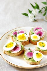watermelon radish sandwich with avocado and egg. healthy balanced breakfast. bright toast
