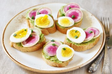watermelon radish sandwich with avocado and egg. healthy balanced breakfast. bright toast