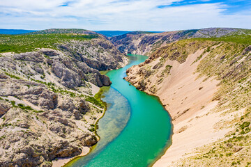 Fototapeta premium Green river with crystal clear water flowing in deep canyon. Zrmanja river canyon. Film location for Winnetou western movies. Beautiful Landscape in Croatia, EU, Europe.