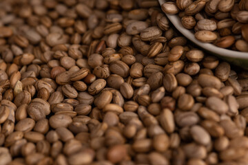 Fototapeta premium Carioquinha type beans over black background. Brazilian beans. Top view
