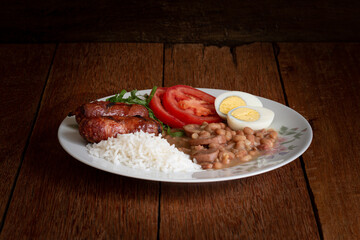 Traditional dish of Brazilian food. Rustic wood background.