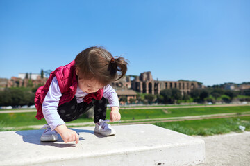little girl playing on the bench
