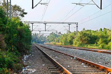 Landscape of railroad tracks in India cutting across rural countryside.