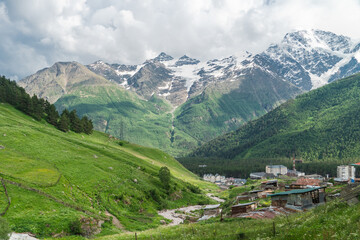 View of highest mountain village in mountains with cloudy sky. Beautiful landscape Caucasus.