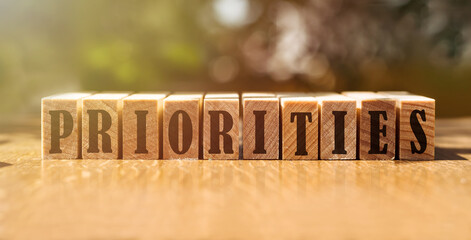 PRIORITIES word made with wood building blocks.