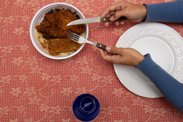 Top view of Styrofoam box with food - Woman taking food from lunch box (Lunch box). Restaurants deliver food to customers homes during the Covid-19 pandemic. Brazilian meal table. Copy space.