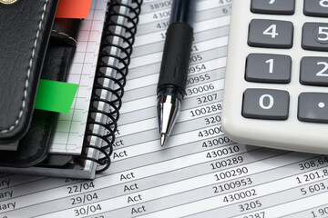 business office desk closeup - financial reports, analysis and accounting, set of documents, tables and graphs, various items for bookkeeping, calculator